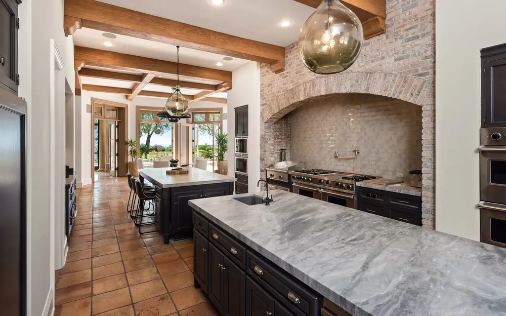9904 Kip Drive Home in Beverly Hills, California. Enter the world of opulence and exclusivity with this celebrity compound behind gated privacy. Designed by KAA Associates, the 25,000 SF estate boasts 7 bedrooms, 13 bathrooms, lush gardens, and stunning canyon, city, and ocean views. 