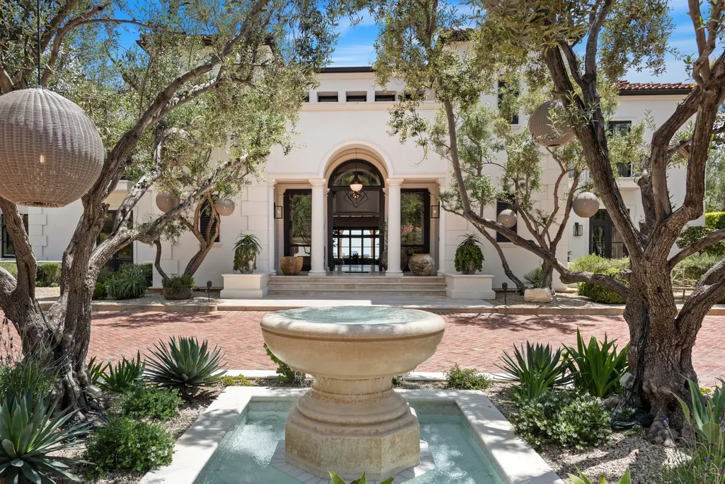9904 Kip Drive Home in Beverly Hills, California. Enter the world of opulence and exclusivity with this celebrity compound behind gated privacy. Designed by KAA Associates, the 25,000 SF estate boasts 7 bedrooms, 13 bathrooms, lush gardens, and stunning canyon, city, and ocean views. 