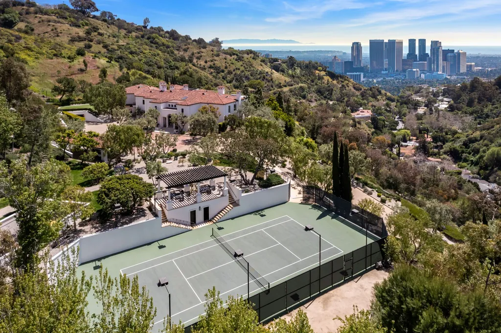 9904 Kip Drive Home in Beverly Hills, California. Enter the world of opulence and exclusivity with this celebrity compound behind gated privacy. Designed by KAA Associates, the 25,000 SF estate boasts 7 bedrooms, 13 bathrooms, lush gardens, and stunning canyon, city, and ocean views. 