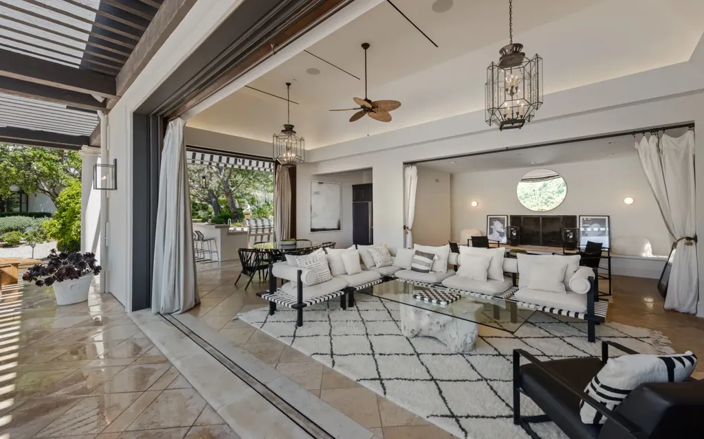 9904 Kip Drive Home in Beverly Hills, California. Enter the world of opulence and exclusivity with this celebrity compound behind gated privacy. Designed by KAA Associates, the 25,000 SF estate boasts 7 bedrooms, 13 bathrooms, lush gardens, and stunning canyon, city, and ocean views. 