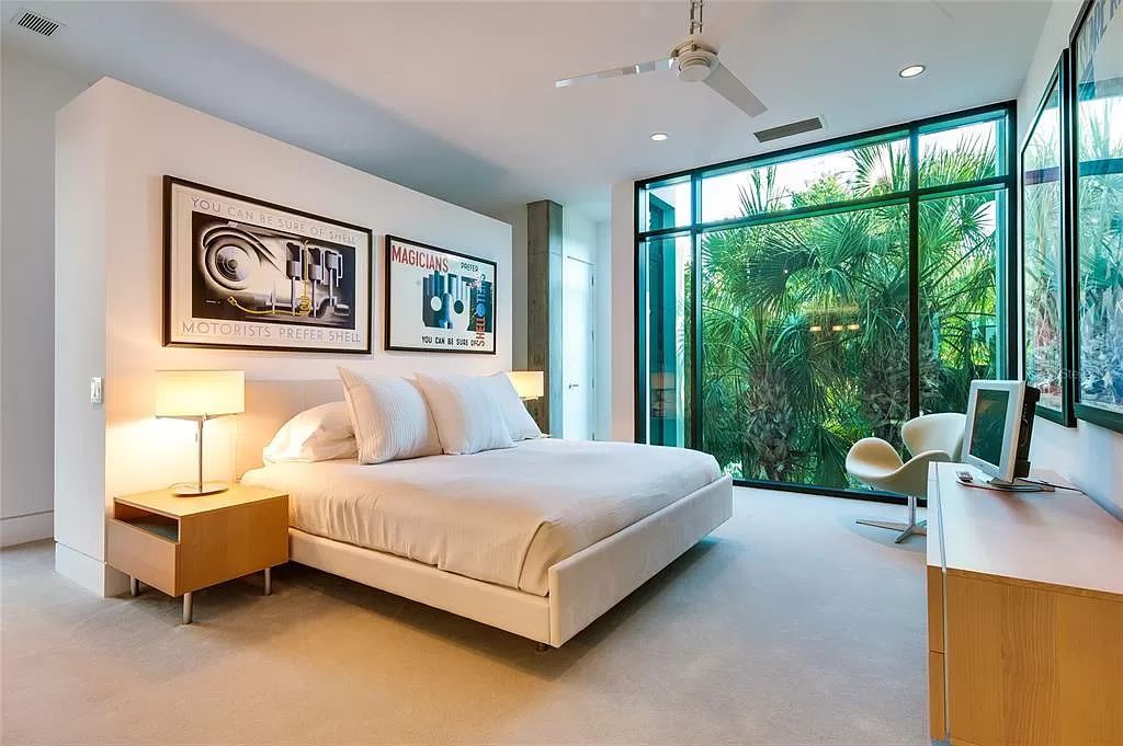 Welcome to 8250 Sanderling Road, a stunning contemporary masterpiece by renowned architect Guy Peterson FAIA, nestled within the exclusive Sanderling Club on Siesta Key. This award-winning property boasts a striking exterior composed of interconnected pavilions, recognized for its architectural excellence by the Florida Gulf Coast Chapter of the AIA and featured in prestigious publications like HGTV Homes Across America