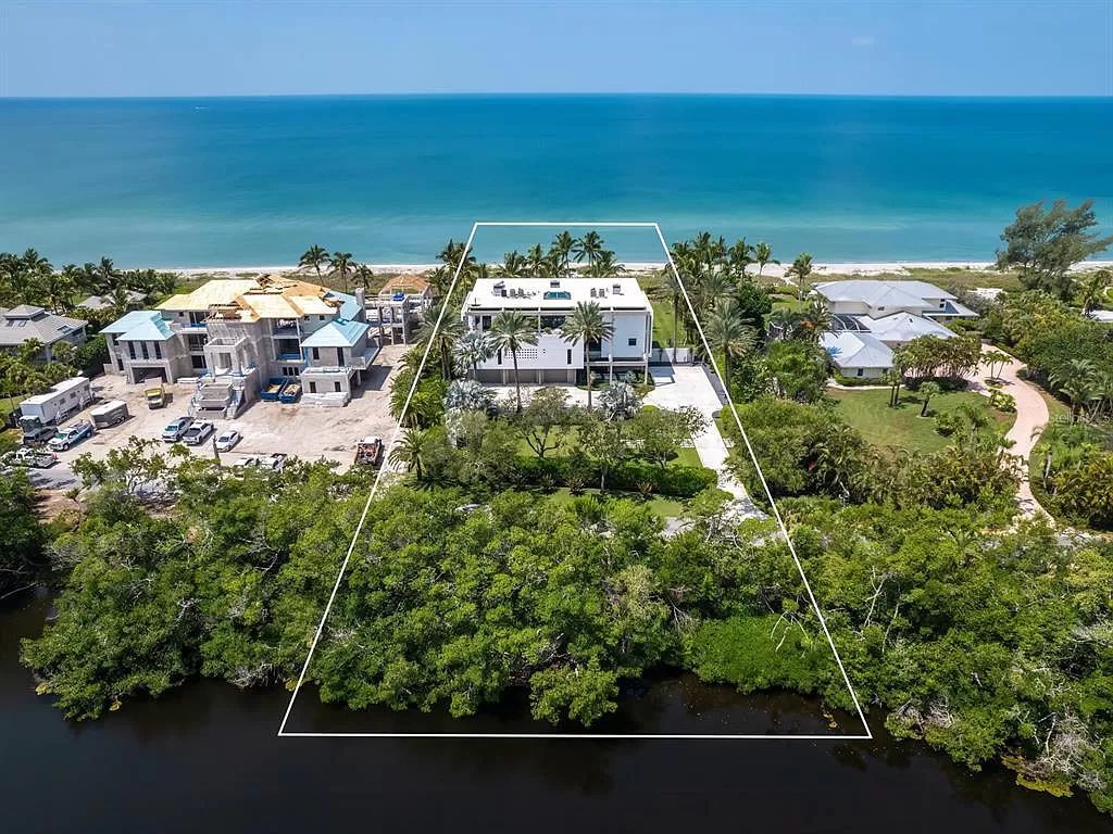 Welcome to 8250 Sanderling Road, a stunning contemporary masterpiece by renowned architect Guy Peterson FAIA, nestled within the exclusive Sanderling Club on Siesta Key. This award-winning property boasts a striking exterior composed of interconnected pavilions, recognized for its architectural excellence by the Florida Gulf Coast Chapter of the AIA and featured in prestigious publications like HGTV Homes Across America