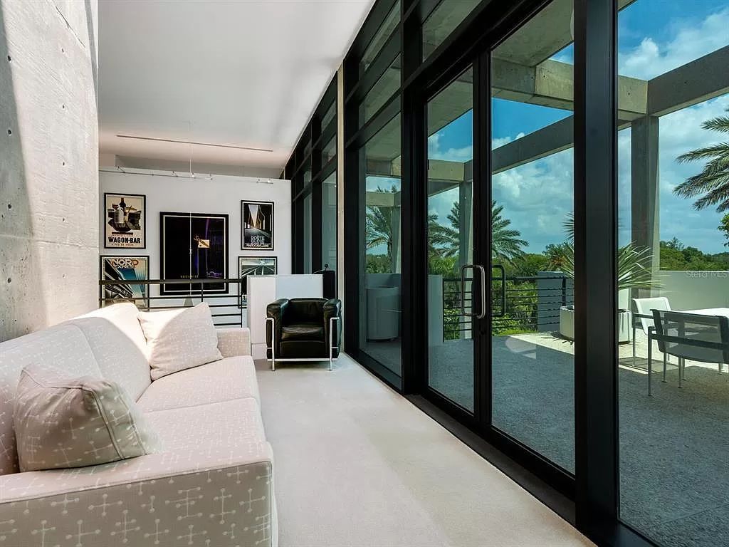 Welcome to 8250 Sanderling Road, a stunning contemporary masterpiece by renowned architect Guy Peterson FAIA, nestled within the exclusive Sanderling Club on Siesta Key. This award-winning property boasts a striking exterior composed of interconnected pavilions, recognized for its architectural excellence by the Florida Gulf Coast Chapter of the AIA and featured in prestigious publications like HGTV Homes Across America