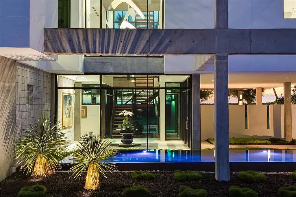 Welcome to 8250 Sanderling Road, a stunning contemporary masterpiece by renowned architect Guy Peterson FAIA, nestled within the exclusive Sanderling Club on Siesta Key. This award-winning property boasts a striking exterior composed of interconnected pavilions, recognized for its architectural excellence by the Florida Gulf Coast Chapter of the AIA and featured in prestigious publications like HGTV Homes Across America