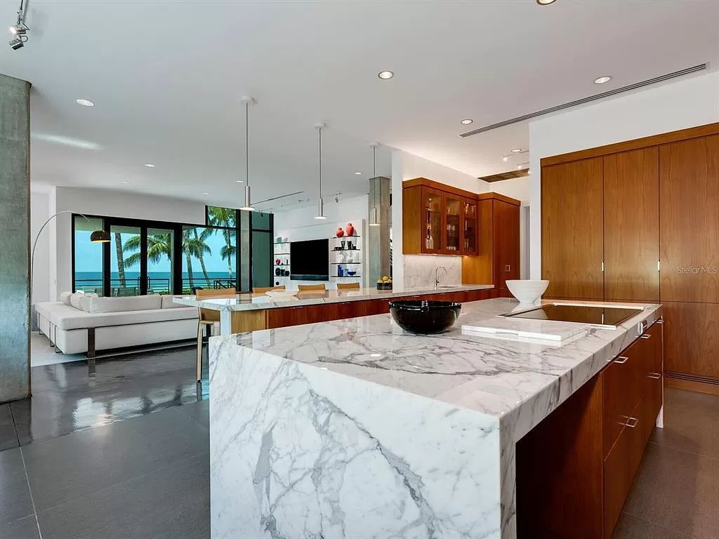 Welcome to 8250 Sanderling Road, a stunning contemporary masterpiece by renowned architect Guy Peterson FAIA, nestled within the exclusive Sanderling Club on Siesta Key. This award-winning property boasts a striking exterior composed of interconnected pavilions, recognized for its architectural excellence by the Florida Gulf Coast Chapter of the AIA and featured in prestigious publications like HGTV Homes Across America