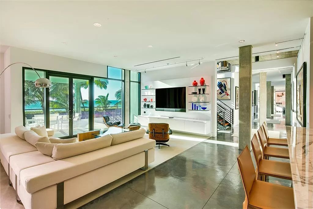 Welcome to 8250 Sanderling Road, a stunning contemporary masterpiece by renowned architect Guy Peterson FAIA, nestled within the exclusive Sanderling Club on Siesta Key. This award-winning property boasts a striking exterior composed of interconnected pavilions, recognized for its architectural excellence by the Florida Gulf Coast Chapter of the AIA and featured in prestigious publications like HGTV Homes Across America