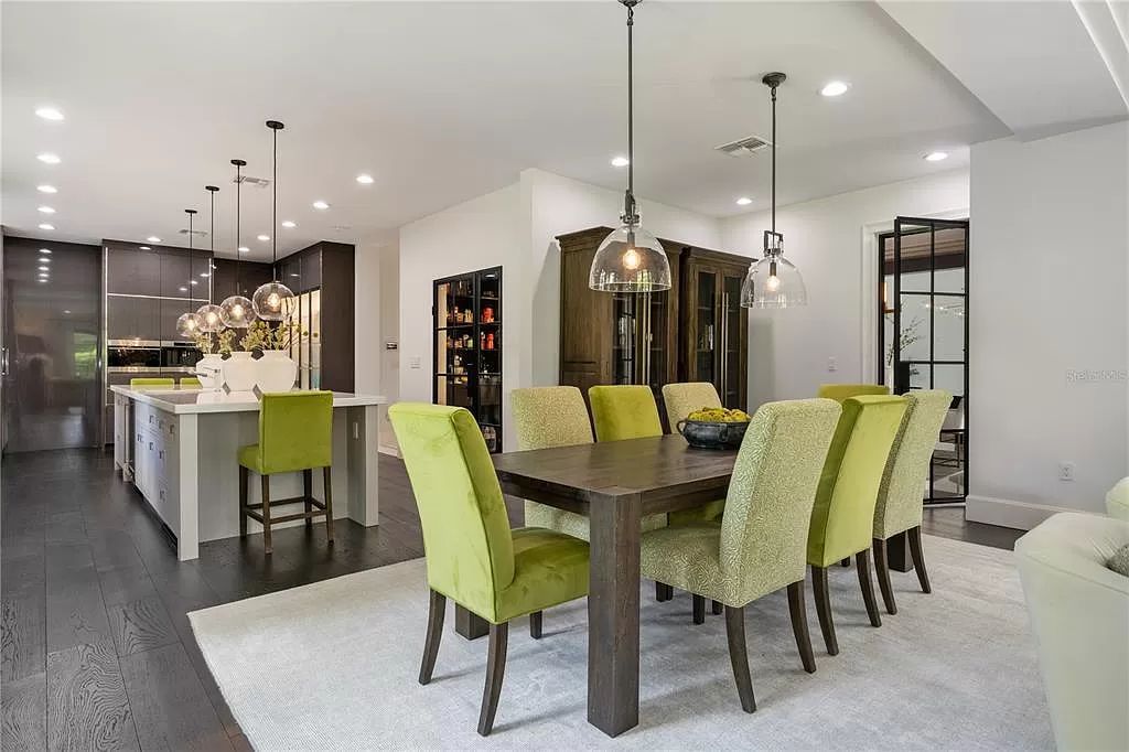 Discover Winter Park's epitome of luxury living in this architectural masterpiece by award-winning architect Larry Boerder. Just steps from Park Avenue's upscale boutiques and restaurants, this 2021-built estate boasts opulence at every turn.