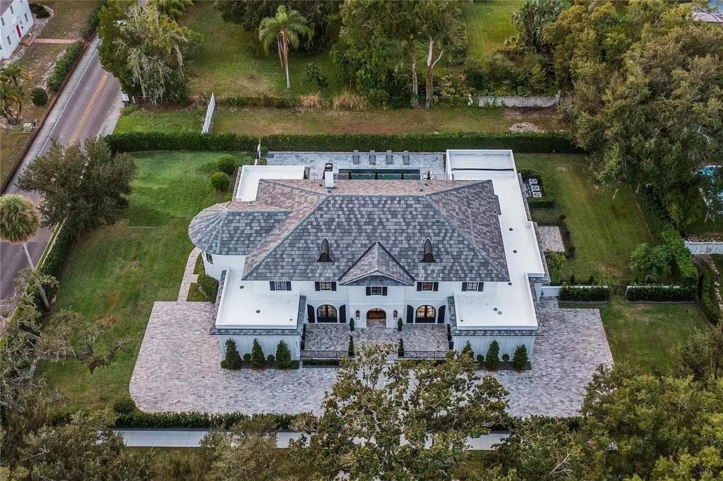 Discover Winter Park's epitome of luxury living in this architectural masterpiece by award-winning architect Larry Boerder. Just steps from Park Avenue's upscale boutiques and restaurants, this 2021-built estate boasts opulence at every turn.