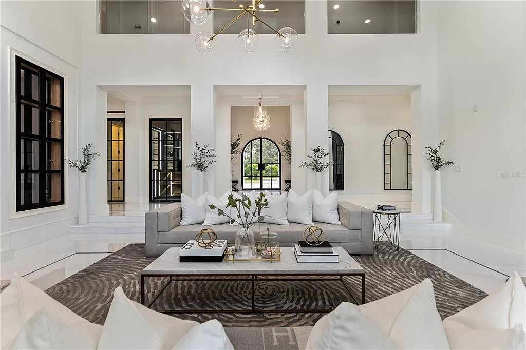 Discover Winter Park's epitome of luxury living in this architectural masterpiece by award-winning architect Larry Boerder. Just steps from Park Avenue's upscale boutiques and restaurants, this 2021-built estate boasts opulence at every turn.