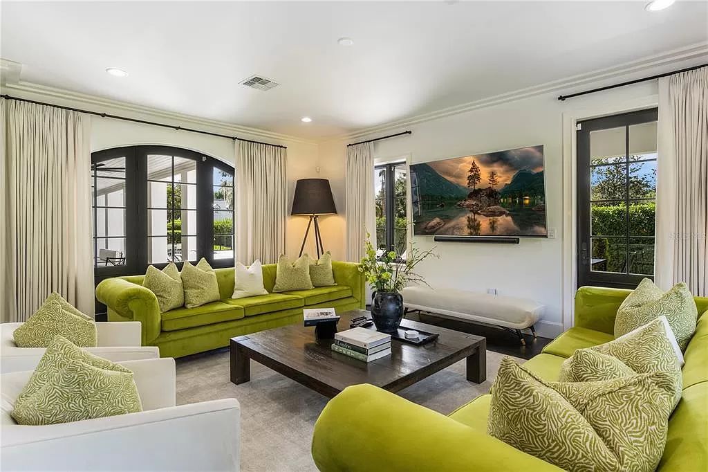 Discover Winter Park's epitome of luxury living in this architectural masterpiece by award-winning architect Larry Boerder. Just steps from Park Avenue's upscale boutiques and restaurants, this 2021-built estate boasts opulence at every turn.