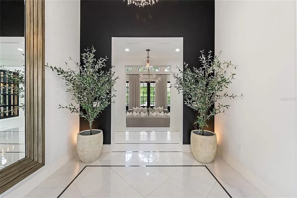 Discover Winter Park's epitome of luxury living in this architectural masterpiece by award-winning architect Larry Boerder. Just steps from Park Avenue's upscale boutiques and restaurants, this 2021-built estate boasts opulence at every turn.