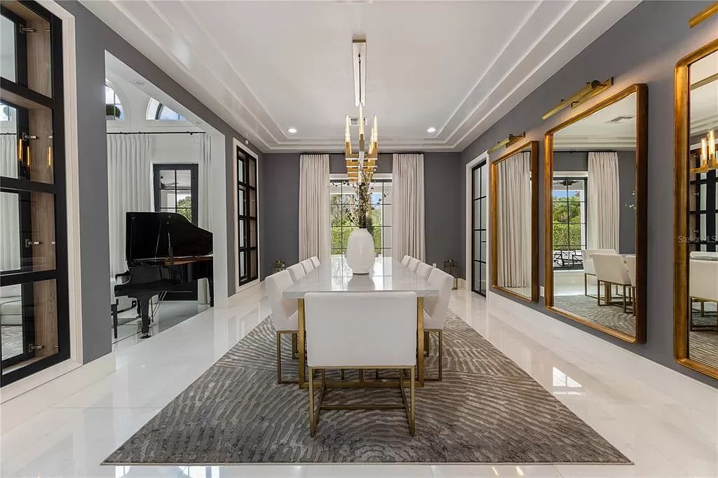 Discover Winter Park's epitome of luxury living in this architectural masterpiece by award-winning architect Larry Boerder. Just steps from Park Avenue's upscale boutiques and restaurants, this 2021-built estate boasts opulence at every turn.