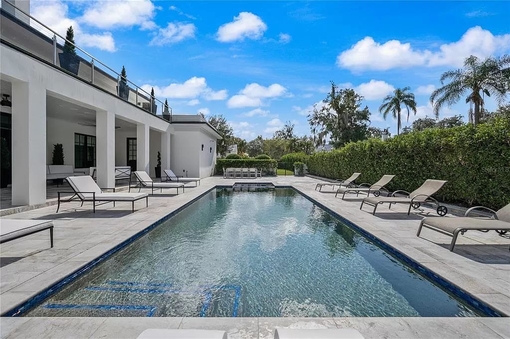 Discover Winter Park's epitome of luxury living in this architectural masterpiece by award-winning architect Larry Boerder. Just steps from Park Avenue's upscale boutiques and restaurants, this 2021-built estate boasts opulence at every turn.