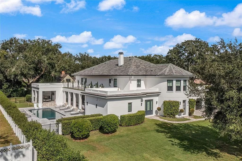 Discover Winter Park's epitome of luxury living in this architectural masterpiece by award-winning architect Larry Boerder. Just steps from Park Avenue's upscale boutiques and restaurants, this 2021-built estate boasts opulence at every turn.