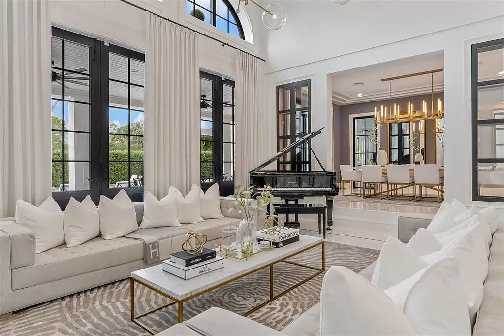 Discover Winter Park's epitome of luxury living in this architectural masterpiece by award-winning architect Larry Boerder. Just steps from Park Avenue's upscale boutiques and restaurants, this 2021-built estate boasts opulence at every turn.