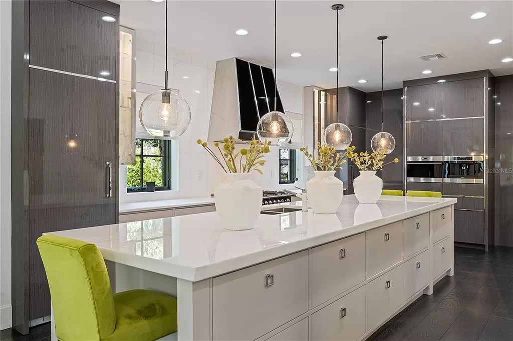 Discover Winter Park's epitome of luxury living in this architectural masterpiece by award-winning architect Larry Boerder. Just steps from Park Avenue's upscale boutiques and restaurants, this 2021-built estate boasts opulence at every turn.