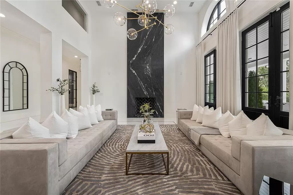 Discover Winter Park's epitome of luxury living in this architectural masterpiece by award-winning architect Larry Boerder. Just steps from Park Avenue's upscale boutiques and restaurants, this 2021-built estate boasts opulence at every turn.