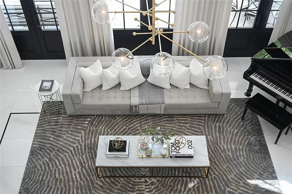Discover Winter Park's epitome of luxury living in this architectural masterpiece by award-winning architect Larry Boerder. Just steps from Park Avenue's upscale boutiques and restaurants, this 2021-built estate boasts opulence at every turn.