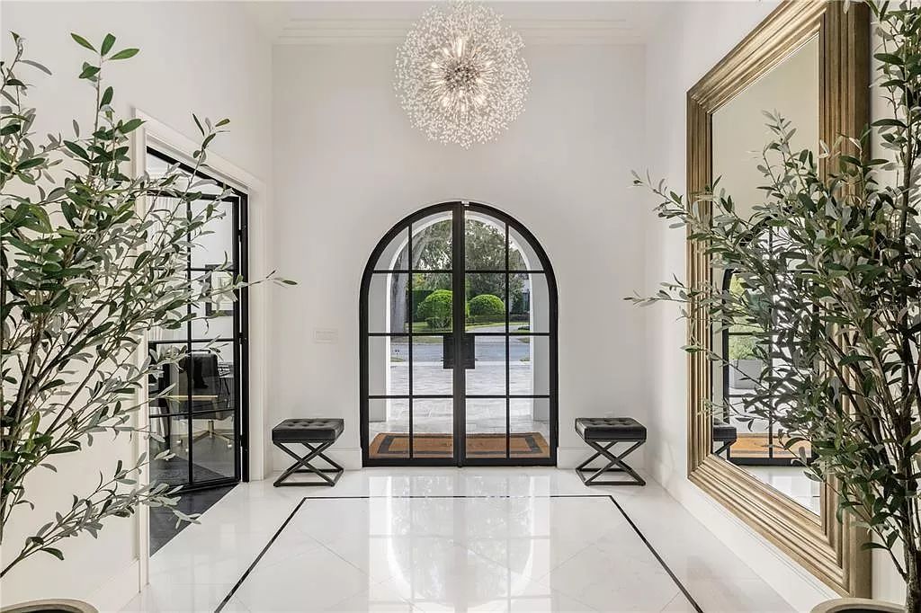 Discover Winter Park's epitome of luxury living in this architectural masterpiece by award-winning architect Larry Boerder. Just steps from Park Avenue's upscale boutiques and restaurants, this 2021-built estate boasts opulence at every turn.