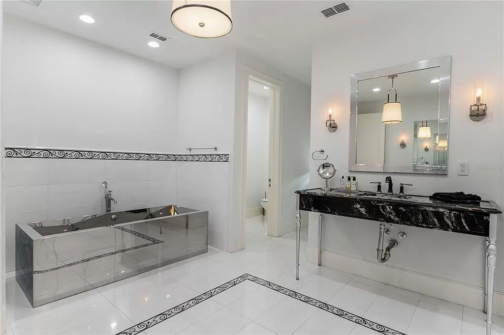 Discover Winter Park's epitome of luxury living in this architectural masterpiece by award-winning architect Larry Boerder. Just steps from Park Avenue's upscale boutiques and restaurants, this 2021-built estate boasts opulence at every turn.