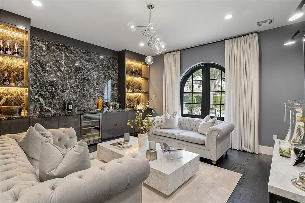 Discover Winter Park's epitome of luxury living in this architectural masterpiece by award-winning architect Larry Boerder. Just steps from Park Avenue's upscale boutiques and restaurants, this 2021-built estate boasts opulence at every turn.