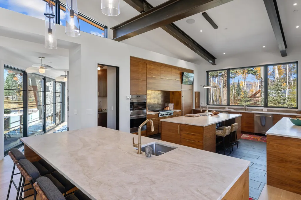 110 Highlands Way Home in Mountain Village, Colorado. Discover the epitome of mountain living in this 5-bedroom, 7.5-bathroom luxury home with direct ski-in/ski-out access via the Galloping Goose trail. Recently constructed, this mountain modern retreat offers breathtaking San Sophia mountain views, an open-concept design, and high-end finishes. 