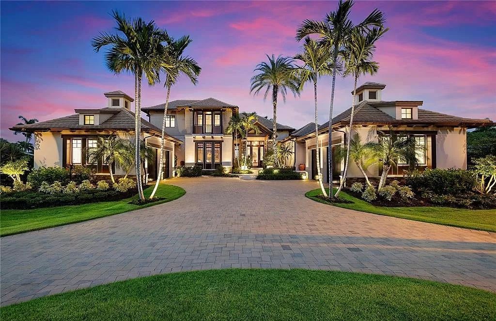 Discover the epitome of luxury living in the heart of Naples at 655 Bougainvillea Rd. This exquisite 7,660-square-foot lakefront estate, crafted by renowned architect John Cooney, boasts a seamless blend of warm tones and minimalist design.