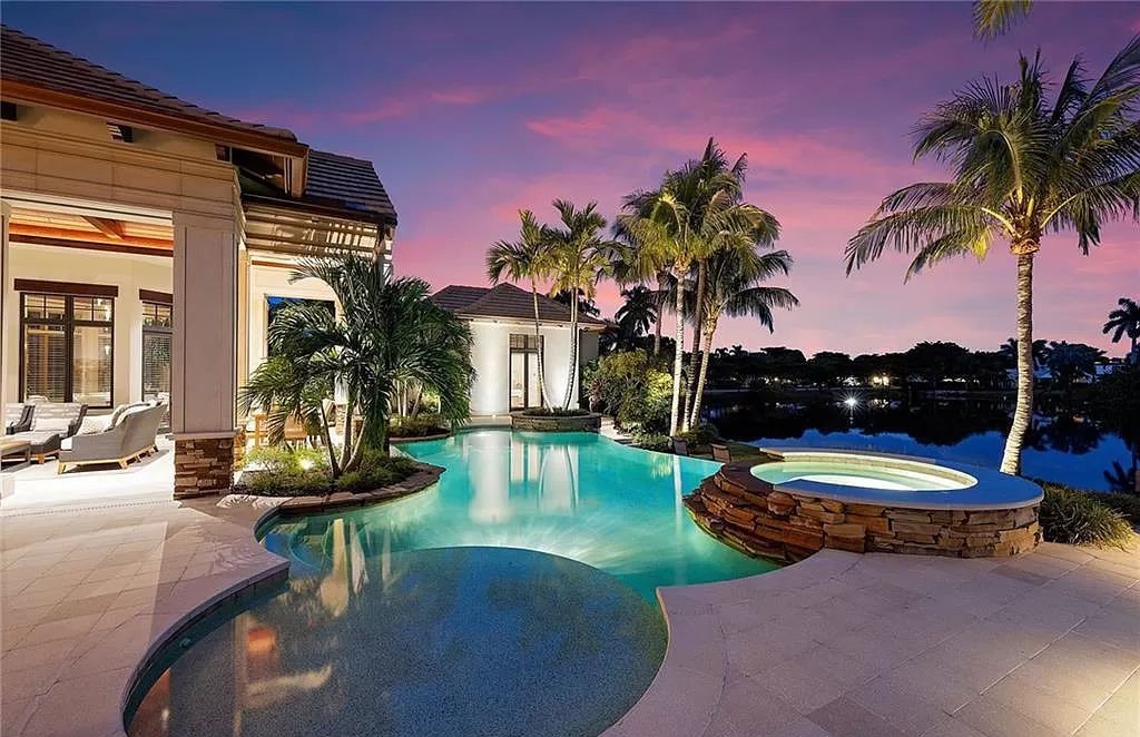Discover the epitome of luxury living in the heart of Naples at 655 Bougainvillea Rd. This exquisite 7,660-square-foot lakefront estate, crafted by renowned architect John Cooney, boasts a seamless blend of warm tones and minimalist design.