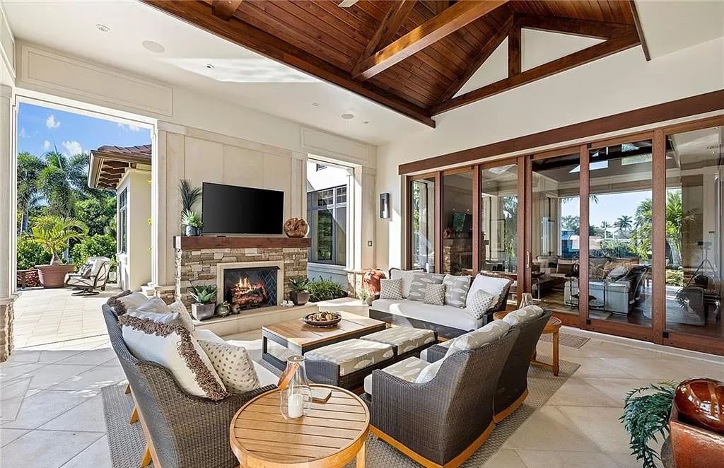 Discover the epitome of luxury living in the heart of Naples at 655 Bougainvillea Rd. This exquisite 7,660-square-foot lakefront estate, crafted by renowned architect John Cooney, boasts a seamless blend of warm tones and minimalist design.