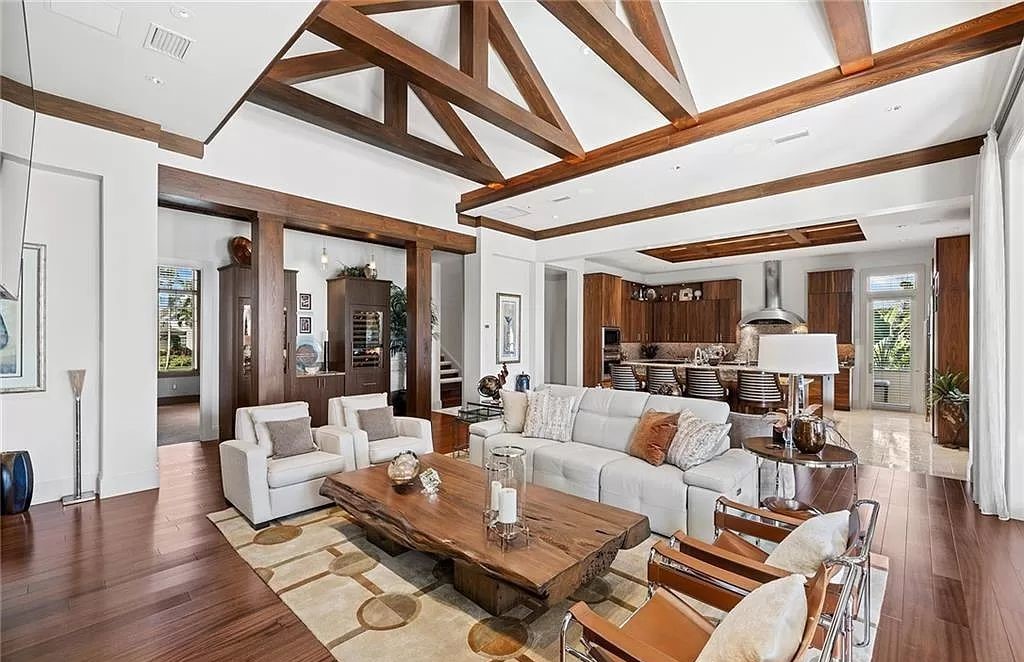 Discover the epitome of luxury living in the heart of Naples at 655 Bougainvillea Rd. This exquisite 7,660-square-foot lakefront estate, crafted by renowned architect John Cooney, boasts a seamless blend of warm tones and minimalist design.