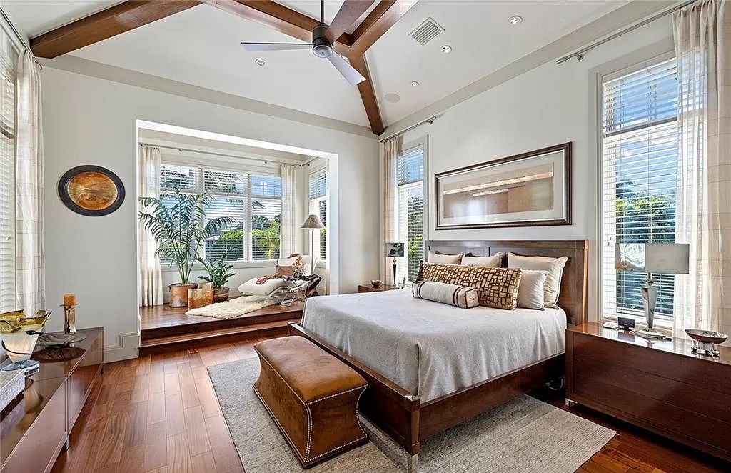 Discover the epitome of luxury living in the heart of Naples at 655 Bougainvillea Rd. This exquisite 7,660-square-foot lakefront estate, crafted by renowned architect John Cooney, boasts a seamless blend of warm tones and minimalist design.