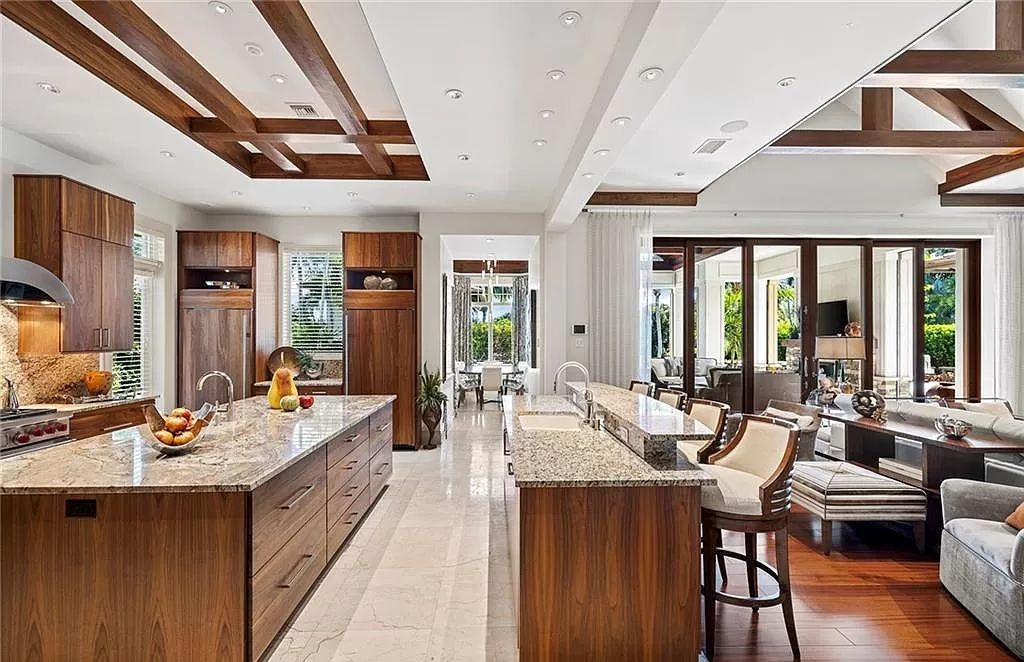 Discover the epitome of luxury living in the heart of Naples at 655 Bougainvillea Rd. This exquisite 7,660-square-foot lakefront estate, crafted by renowned architect John Cooney, boasts a seamless blend of warm tones and minimalist design.