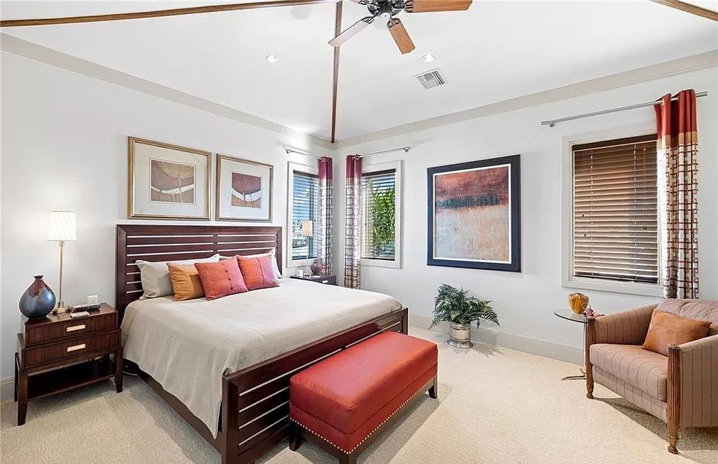 Discover the epitome of luxury living in the heart of Naples at 655 Bougainvillea Rd. This exquisite 7,660-square-foot lakefront estate, crafted by renowned architect John Cooney, boasts a seamless blend of warm tones and minimalist design.