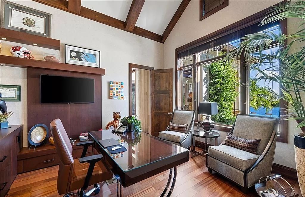 Discover the epitome of luxury living in the heart of Naples at 655 Bougainvillea Rd. This exquisite 7,660-square-foot lakefront estate, crafted by renowned architect John Cooney, boasts a seamless blend of warm tones and minimalist design.
