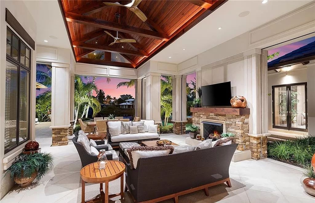 Discover the epitome of luxury living in the heart of Naples at 655 Bougainvillea Rd. This exquisite 7,660-square-foot lakefront estate, crafted by renowned architect John Cooney, boasts a seamless blend of warm tones and minimalist design.