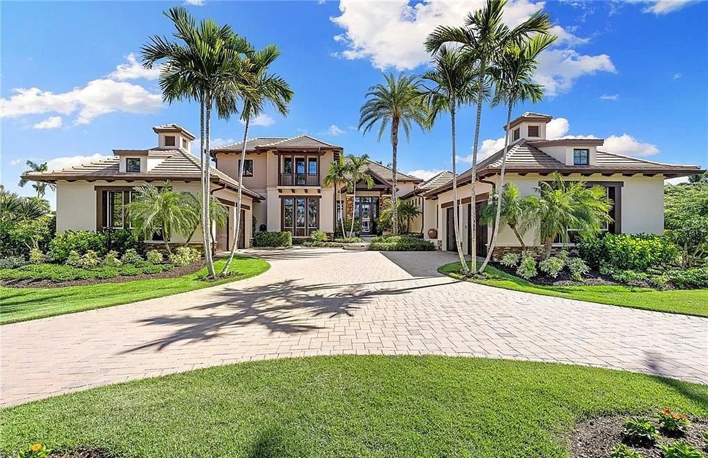 Discover the epitome of luxury living in the heart of Naples at 655 Bougainvillea Rd. This exquisite 7,660-square-foot lakefront estate, crafted by renowned architect John Cooney, boasts a seamless blend of warm tones and minimalist design.