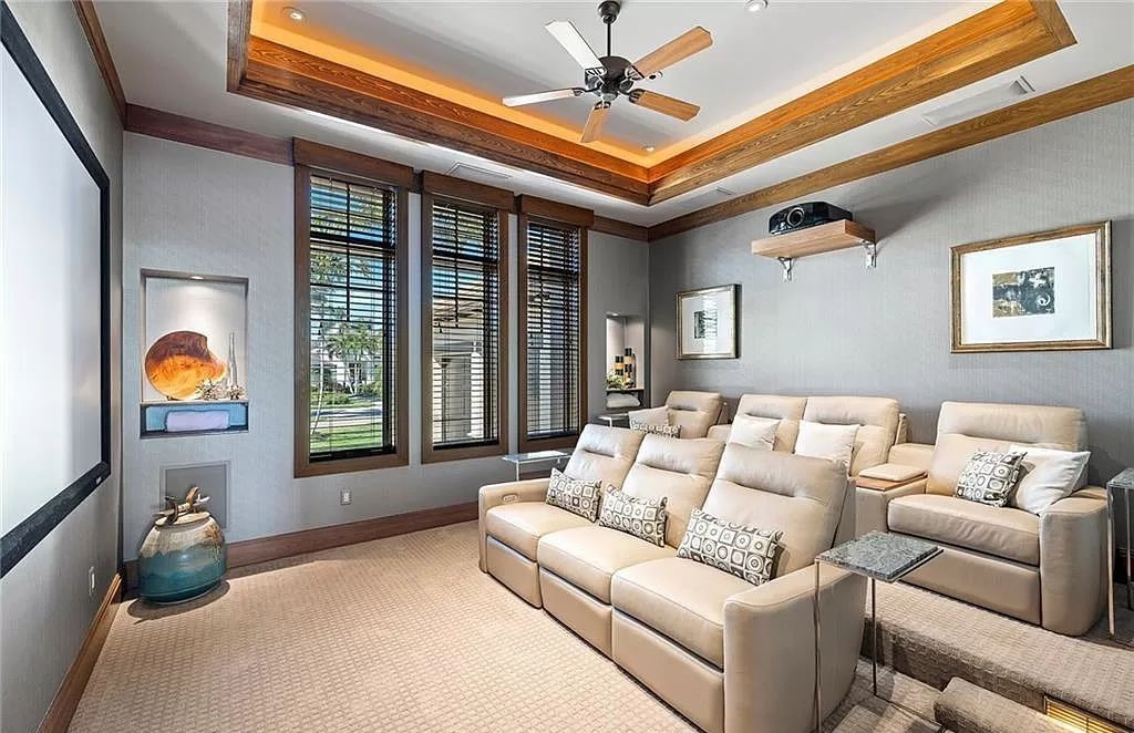 Discover the epitome of luxury living in the heart of Naples at 655 Bougainvillea Rd. This exquisite 7,660-square-foot lakefront estate, crafted by renowned architect John Cooney, boasts a seamless blend of warm tones and minimalist design.