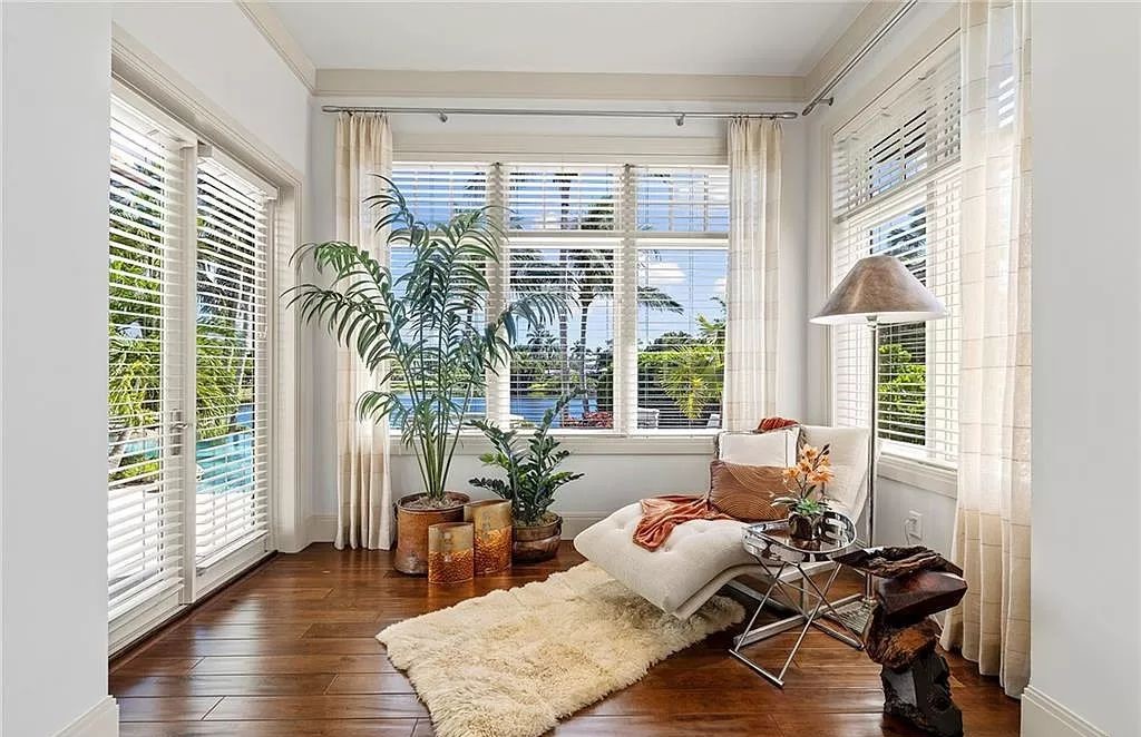 Discover the epitome of luxury living in the heart of Naples at 655 Bougainvillea Rd. This exquisite 7,660-square-foot lakefront estate, crafted by renowned architect John Cooney, boasts a seamless blend of warm tones and minimalist design.