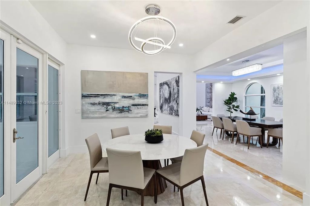 Welcome to the epitome of contemporary luxury living in Pinecrest! This striking newly constructed family compound offers a seamless blend of timeless transitional style and modern functionality. Spanning 7,778 square feet on a lush 0.89-acre lot, this masterpiece features two separate family quarters with flexible spaces, ideal for multi-generational living or personalized workspaces.