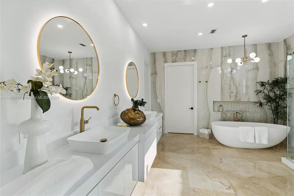 Welcome to the epitome of contemporary luxury living in Pinecrest! This striking newly constructed family compound offers a seamless blend of timeless transitional style and modern functionality. Spanning 7,778 square feet on a lush 0.89-acre lot, this masterpiece features two separate family quarters with flexible spaces, ideal for multi-generational living or personalized workspaces.