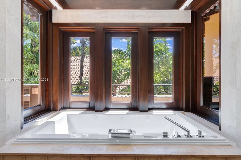 Experience the epitome of Mediterranean luxury at 230 Bal Bay Dr, an exclusive waterfront estate in Bal Harbour Village. Crafted by the esteemed Alexander Group, this custom-built masterpiece boasts exquisite details like custom millwork, Jerusalem stone flooring, and marble accents throughout.