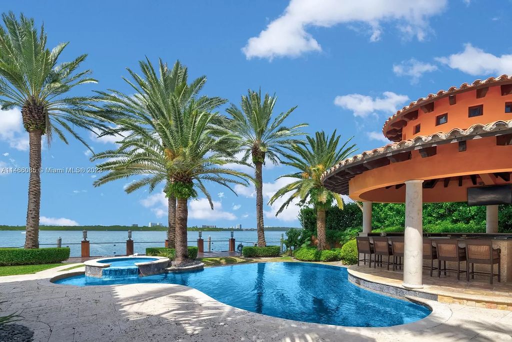 Experience the epitome of Mediterranean luxury at 230 Bal Bay Dr, an exclusive waterfront estate in Bal Harbour Village. Crafted by the esteemed Alexander Group, this custom-built masterpiece boasts exquisite details like custom millwork, Jerusalem stone flooring, and marble accents throughout.