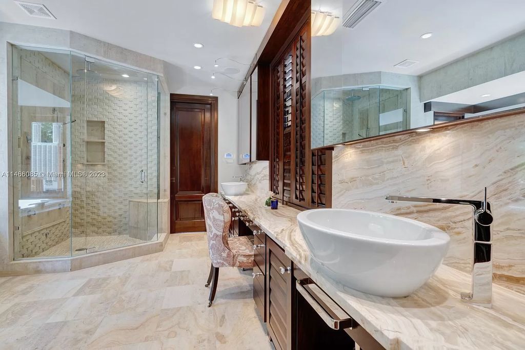 Experience the epitome of Mediterranean luxury at 230 Bal Bay Dr, an exclusive waterfront estate in Bal Harbour Village. Crafted by the esteemed Alexander Group, this custom-built masterpiece boasts exquisite details like custom millwork, Jerusalem stone flooring, and marble accents throughout.