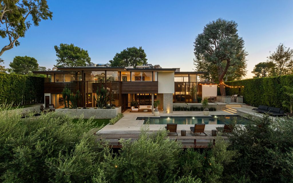 1875 Carla Ridge Home in Beverly Hills, California. Behold an architectural masterpiece designed by Rex Lotery in 1965—a stunning Mid-Century home crafted with concrete, wood, glass, and stone. This rare gem stands out as one of only a handful of two-story homes in the coveted Trousdale neighborhood, and it has recently undergone a meticulous renovation to enhance its timeless allure.