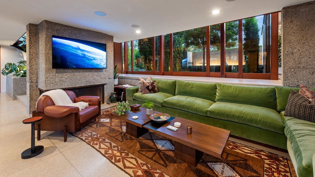 1875 Carla Ridge Home in Beverly Hills, California. Behold an architectural masterpiece designed by Rex Lotery in 1965—a stunning Mid-Century home crafted with concrete, wood, glass, and stone. This rare gem stands out as one of only a handful of two-story homes in the coveted Trousdale neighborhood, and it has recently undergone a meticulous renovation to enhance its timeless allure.