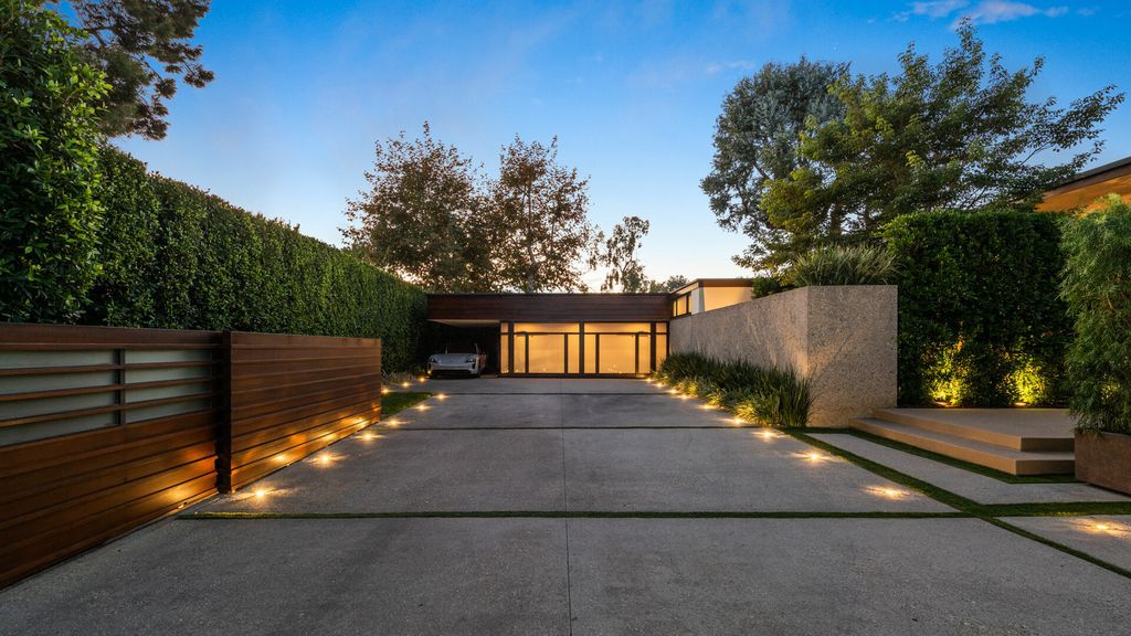1875 Carla Ridge Home in Beverly Hills, California. Behold an architectural masterpiece designed by Rex Lotery in 1965—a stunning Mid-Century home crafted with concrete, wood, glass, and stone. This rare gem stands out as one of only a handful of two-story homes in the coveted Trousdale neighborhood, and it has recently undergone a meticulous renovation to enhance its timeless allure.