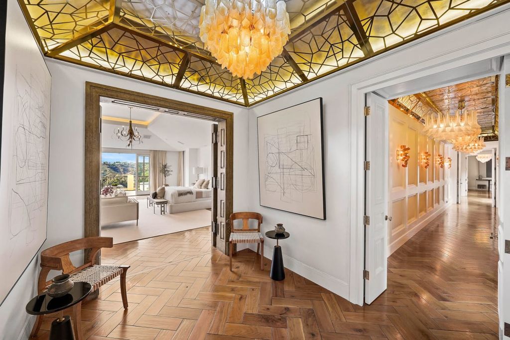 2505 Summitridge Drive Home in Beverly Hills, California, Discover the epitome of luxury living in this custom 9-bedroom, 11-bathroom estate nestled within the exclusive Bella Vista community in Beverly Hills. Boasting sophisticated amenities such as a private park, basketball court, and unobstructed canyon views, this residence seamlessly blends old-world Italian charm with modern technology.