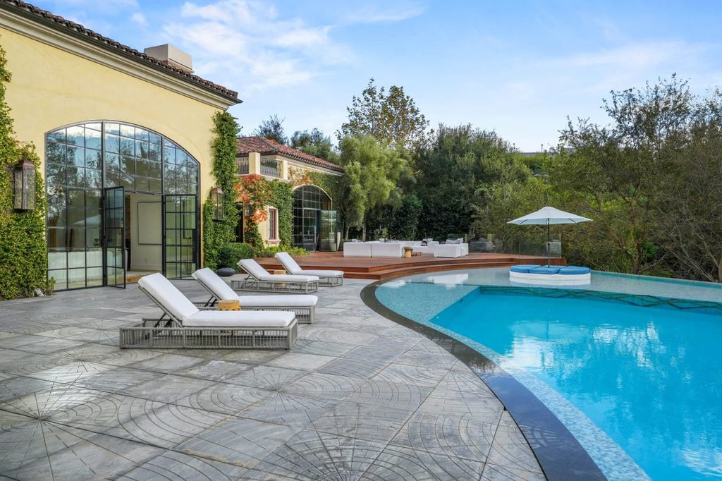 2505 Summitridge Drive Home in Beverly Hills, California, Discover the epitome of luxury living in this custom 9-bedroom, 11-bathroom estate nestled within the exclusive Bella Vista community in Beverly Hills. Boasting sophisticated amenities such as a private park, basketball court, and unobstructed canyon views, this residence seamlessly blends old-world Italian charm with modern technology.