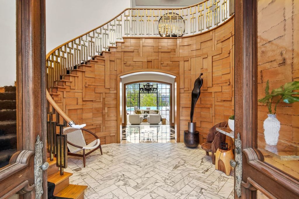 2505 Summitridge Drive Home in Beverly Hills, California, Discover the epitome of luxury living in this custom 9-bedroom, 11-bathroom estate nestled within the exclusive Bella Vista community in Beverly Hills. Boasting sophisticated amenities such as a private park, basketball court, and unobstructed canyon views, this residence seamlessly blends old-world Italian charm with modern technology.