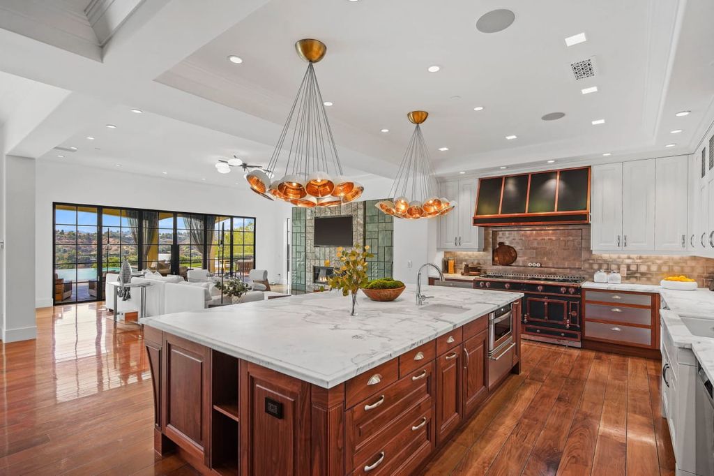 2505 Summitridge Drive Home in Beverly Hills, California, Discover the epitome of luxury living in this custom 9-bedroom, 11-bathroom estate nestled within the exclusive Bella Vista community in Beverly Hills. Boasting sophisticated amenities such as a private park, basketball court, and unobstructed canyon views, this residence seamlessly blends old-world Italian charm with modern technology.